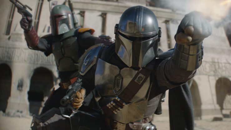 Plano medio con Boba Fett de fondo y Din Djarin al frente.